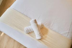 a wrapped up white cast on a bed at Lille Train station nice studio in Lille