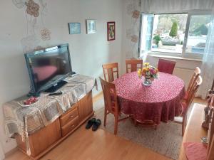 a dining room with a table and a television at Make yourself at home in Vaihingen an der Enz