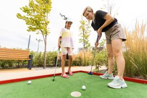 two girls playing golf on a putting green at Lovely Caravan At Hoburne Bashley, New Forest District! Ref 97166s in New Milton