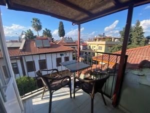 a balcony with a table and chairs on a balcony at Camel Apartment in Antalya