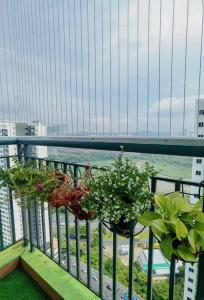 two potted plants on a balcony with a bridge at Pavilion Bukit Jalil, Old Klang Road, Puchong, Bukit OUG, 9 pax B1 in Kuala Lumpur