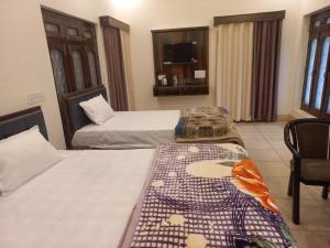 Postel nebo postele na pokoji v ubytování Kalash Guest House
