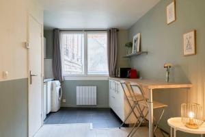 a small kitchen with a table and a window at Equipped studio in Vieux-Lille near Grand Place in Lille