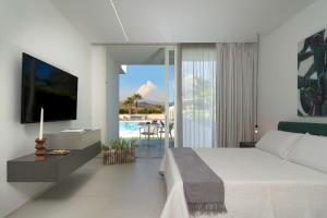 - une chambre avec un lit et une vue sur la piscine dans l'établissement Villa Greta, à Fiumefreddo di Sicilia