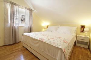 a white bed in a room with a window at Apartment Kovac Old Town 2 in Dubrovnik