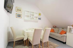 a dining room with a table and chairs and a couch at Apartment Kovac Old Town 2 in Dubrovnik