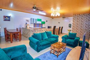 a living room with blue couches and a table at Diani Home Stays in Diani Beach