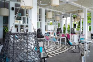 a room with chairs and tables in a building at The Nai Harn in Nai Harn Beach