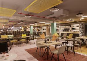 a restaurant with tables and chairs in a room at Expo Hotel Barcelona in Barcelona