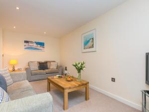 a living room with a couch and a table at Golden Sands in St Ives