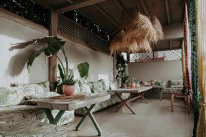 a living room with a couch and tables and plants at Riad 117 in Marrakech