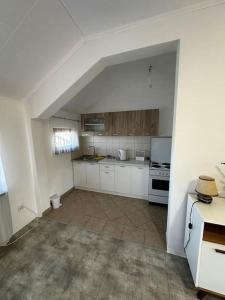 a large kitchen with white cabinets and an attic at Milincic‘s 2 Zimmerwohnung in Banja Luka