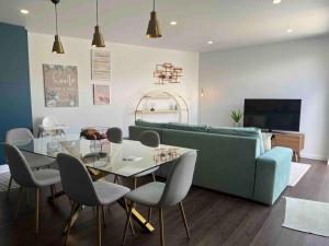 a living room with a couch and a table and chairs at Vento do Nordeste - Cottage with Jacuzzi in Nordeste