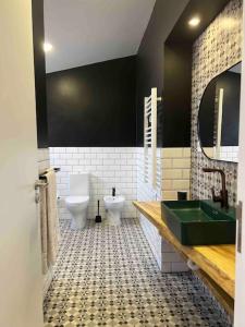 a bathroom with a green sink and a toilet at Vento do Nordeste - Cottage with Jacuzzi in Nordeste +19 photos