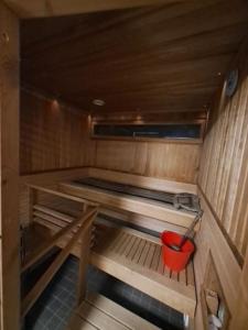 a small room with a red bucket on the inside at Central Cozy 2BDR Getaway Sauna Free Park + Wi-Fi in Helsinki