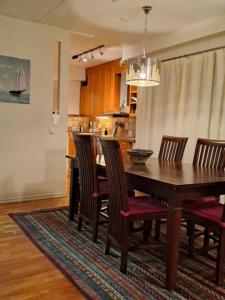 a dining room with a wooden table and chairs at Central Cozy 2BDR Getaway Sauna Free Park + Wi-Fi in Helsinki