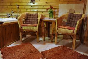 a kitchen with a table and two chairs and a sink at The Edge Of The Village - Shefer in Shefer