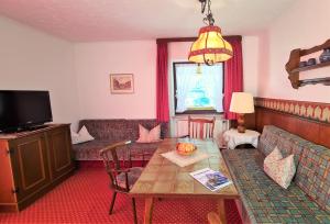 a living room with a couch and a table at Schneck Apartments in Schönau am Königssee