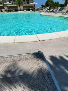 a swimming pool with a metal mat in front of it at Zambrone Mare Appartamento / Piscina / Mare in Zambrone