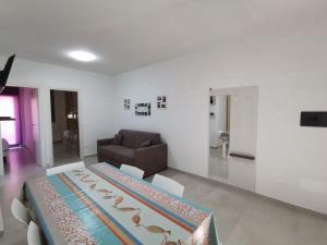 a living room with a bed and a couch at Zambrone Mare Appartamento / Piscina / Mare in Zambrone