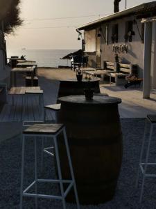 a bar with two chairs and a table and two stools at Zambrone Mare Appartamento / Piscina / Mare in Zambrone
