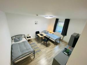 a living room with a bed and a dining room at Ferienwohnungen by K Krause in Salzgitter