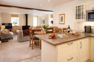 a kitchen and living room with a living room at Dryburgh Steading One in Saint Boswells