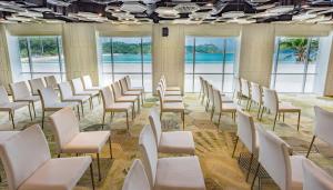 a row of chairs in a room with windows at The Nai Harn in Nai Harn Beach