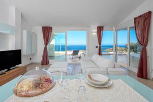 sala de estar con vistas al océano en Villa Marconi Apartment 12a attico, en Golfo Aranci