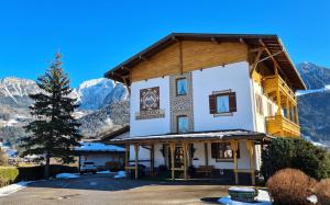 a large building with mountains in the background at Schneck Apartments in Schönau am Königssee