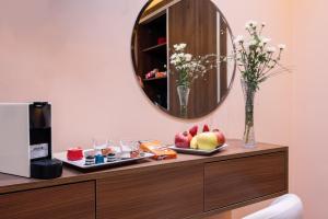 a mirror on top of a dresser in a room at Swiss Continental Hôtel in Marrakesh