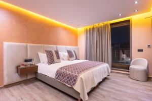 a bedroom with a large white bed and a window at SWISS CONTINENTAL HOTEL And SPA in Marrakesh