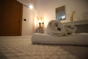 a room with a bed with towels on it at Rubini's House in Giovinazzo +84 photos