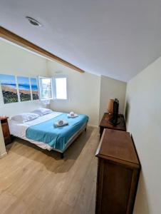 a bedroom with a bed and a table in it at Pastisse YourHostHelper in Anglet