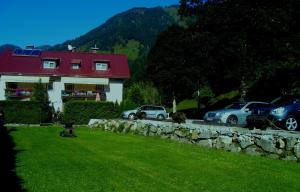 a group of cars parked in front of a house at Paul-S Apartman in Bad Hofgastein