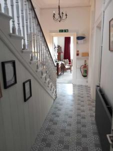 a hallway with a stairway with a hallwayngth at Garway Lodge Guest House in Torquay