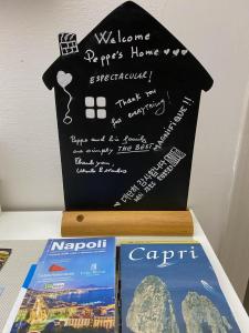un libro y un cartel sobre una mesa en Peppe's Home relax apartament the view, en Gragnano