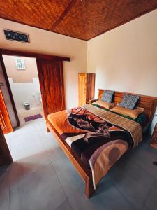 a bedroom with two beds and a bath room at Green Haven Homestay in Tetebatu
