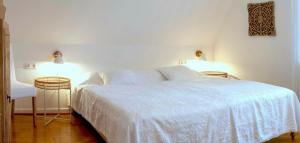 um quarto com uma cama branca e duas mesas de cabeceira em Ferienwohnung am Hafen Bad Bevensen em Bad Bevensen