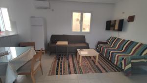 a living room with a couch and a table at CoZi Coliving in Mezraya