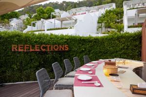 a long table with chairs and plates on it at The Nai Harn in Nai Harn Beach