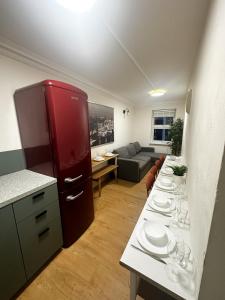 a kitchen with a table with plates and wine glasses at Flat 3 Stay In Aldgate Apartments in London