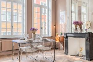 uma sala de jantar com uma mesa e cadeiras e uma lareira em 1 bedroom apartment in the city center, near metro em Lille