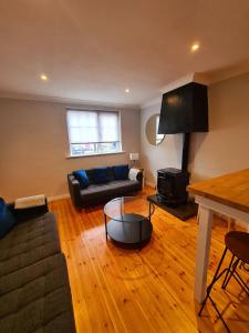 a living room with a couch and a table at Stylish 3 Bedroom Galway House in Galway