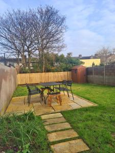 a picnic table and benches in a yard at Stylish 3 Bedroom Galway House in Galway