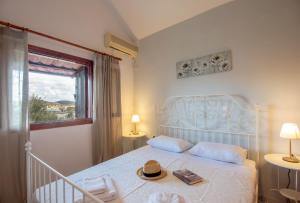 a bedroom with a bed with a hat on it at Elounda Windmills Apartment in Elounda