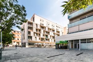 a large building with a plaza in front of it at Top family apartment by Lofties in Terrassa