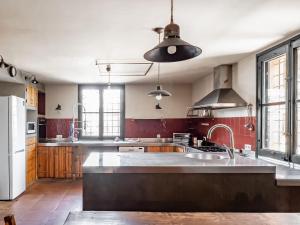 a large kitchen with a large island in the middle at Private country house surrounded by olive trees in Crespiá