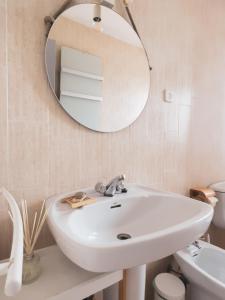 a bathroom with a white sink and a mirror at Majordoms - Apartment Cau del Llop, Llança in Llança +13 photos