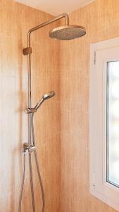 a shower in a bathroom with a shower head at Majordoms - Apartment Cau del Llop, Llança in Llança